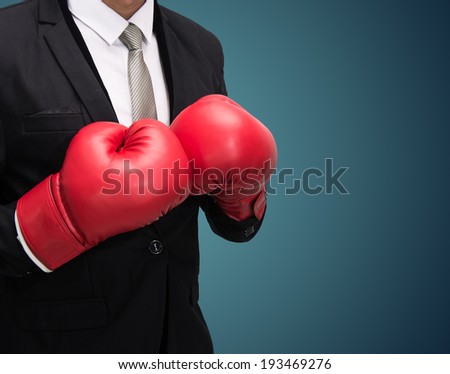 Businessman standing posture in boxing gloves isolated on over blue background