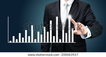 Businessman standing posture hand touch graph finance isolated on dark background