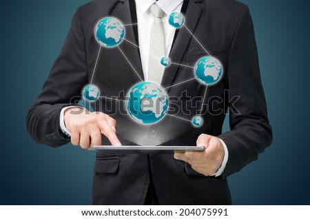 Businessman standing posture hand hold globe map on tablet isolated on dark background