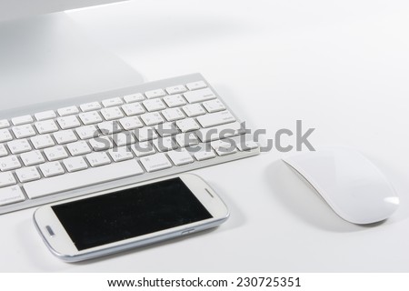 Keyboard mouse and smartphone isolated on white background