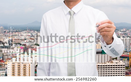 Businessman standing posture hand hold a pen on City  background