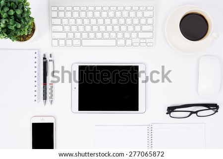 Business desk with a keyboard, mouse and pen on white table