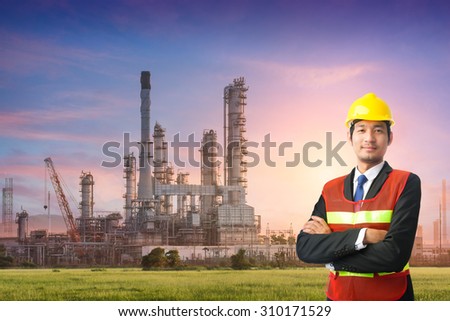 engineering man and safety helmet, shirts standing arms crossed against oil refinery plant in petrochemical industr