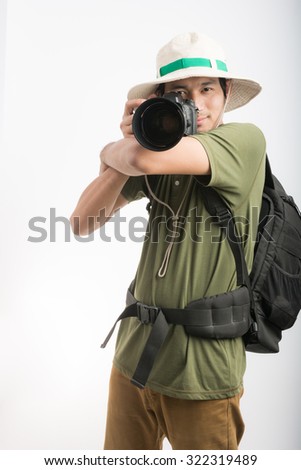 portrait happy asia young man holding camera isolated on a white background