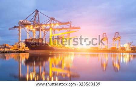 Containers loading by crane at dark sunset, Shipping Trade Port