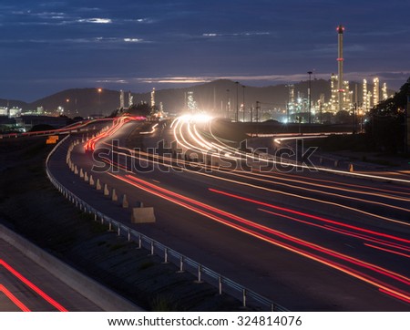 Beautiful lighting of oil refinery plant petrochemical industry with transport