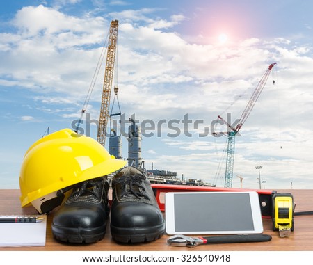 Working table engineer with tablet and tools in building construction crane