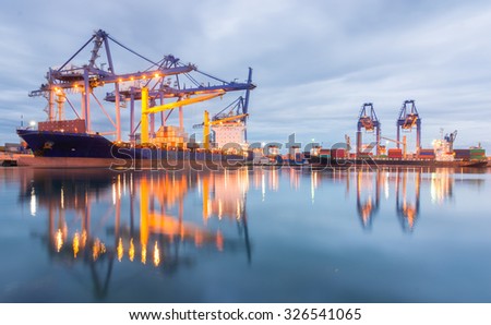 Containers loading Shipping by crane at dark or Trade Port
