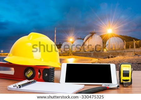 Working table engineer with tablet and tools in oil refinery industry business plant
