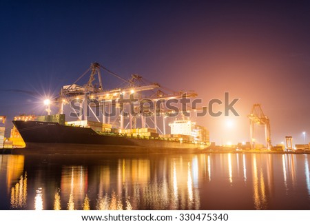 Containers loading by crane on morning dark, Trade Port , Shipping , transport