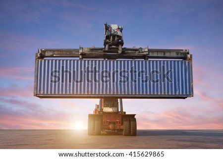 Forklift handling container box loading in the port at Thailand at sunset