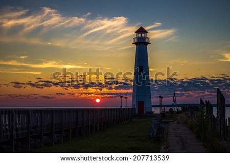 Lighthouse Sunrise. Sunrise along the St. Ignace boardwalk with the Wawatam Lighthouse. St. Ignace, Michigan.