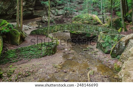 Enchanted Forest. Stone bridge encased in moss crosses a stream. Hocking Hills State Park. Logan, Ohio.