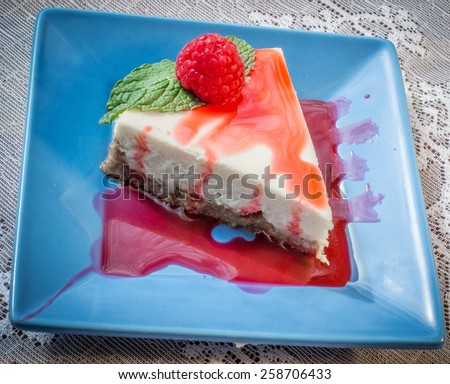 Raspberry Cheesecake. Fresh raspberry cheesecake with mint garnish.