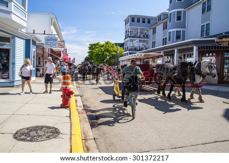 Mackinaw Island, Michigan, USA - July 5, 2015. Mackinaw Island on a busy summer afternoon. The island has a ban on autos and travel around the island is by bike, foot, or horse.