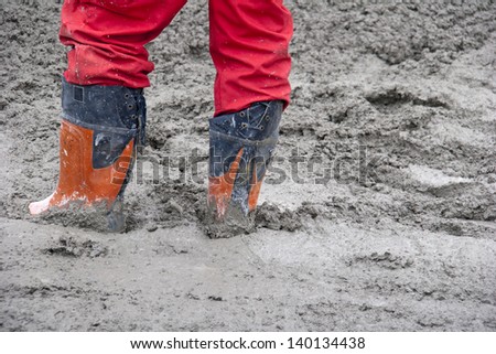 Construction worker in the freshly poured concrete mix