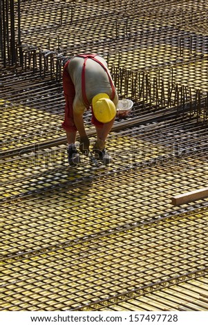 Construction worker between steel bars