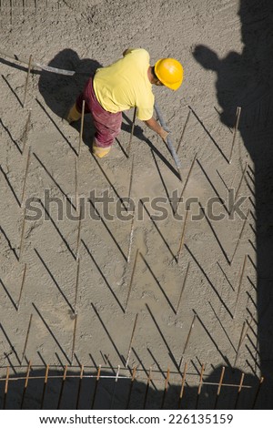 Construction worker vibrating concrete foundations of hydro power plant