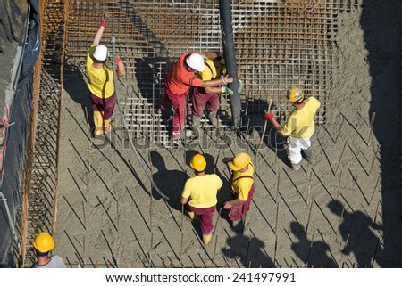 Construction workers casting foundations of hydro power plant