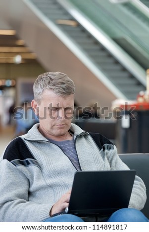 mature man in a waiting room of the modern international airport