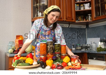 Happy housewife brags of canned food of own preparation