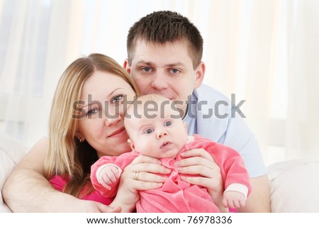 Happy family with the chest baby on hands