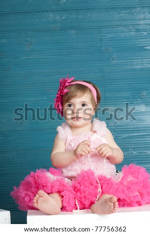 elegant little girl in a bright pink dress