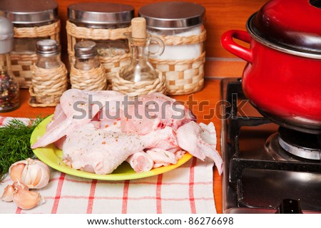 Hen lies on a chopping board. Meal preparation.