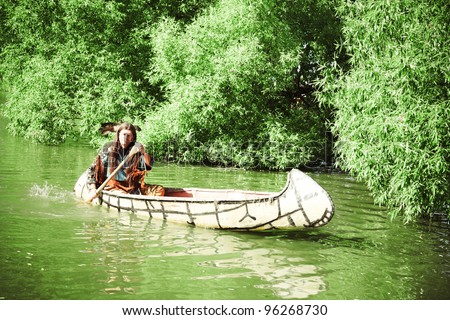 North American Indian floats down the river on a canoe