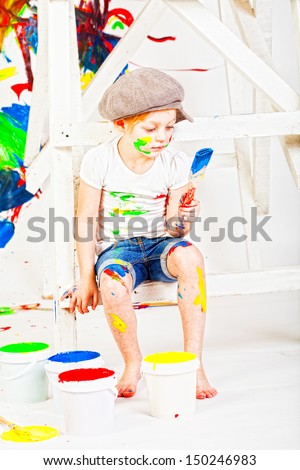 girl in a white T-shirt and a cap bedaubed with bright paints