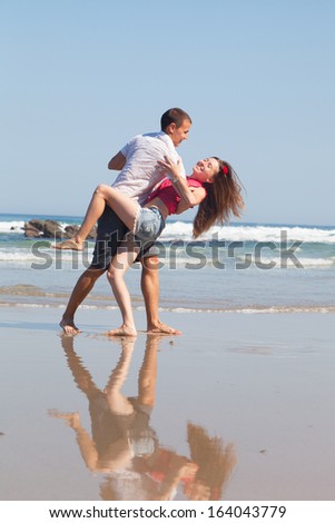 loving couple dances on the sea coast