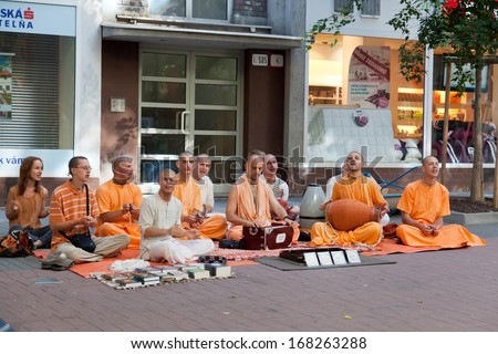 BRATISLAVA, SLOVAKIA - JULY 22: Members of Hare Krishna sit and sing on one of the central streets of Bratislava, Slovakia July 22, 2013