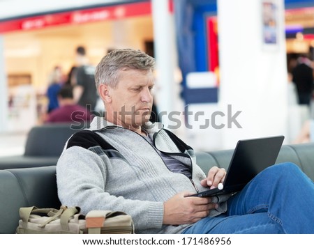 mature man in a waiting room of the modern international airport