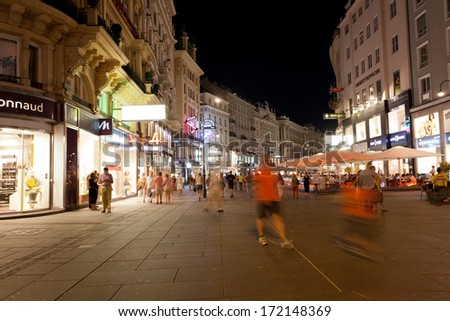 VIENNA, AUSTRIA - JULY 26,2013. Tourists walk at night in center of Vienna, Austria, July 26,2013. population of Vienna makes 1,68 million people, Vienna is  largest on  population the city of Austria