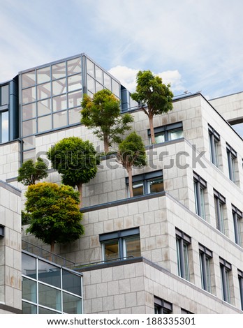 trees growing on a roof of the business center, the solution of environmental problems
