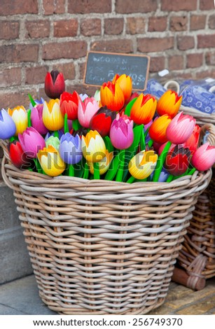 Big basket with tulips - traditional souvenirs from Holland - at shop doors