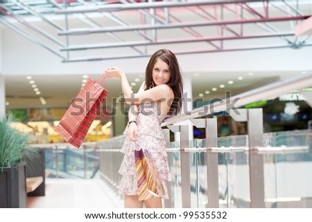 girl with purchases in the big shopping center
