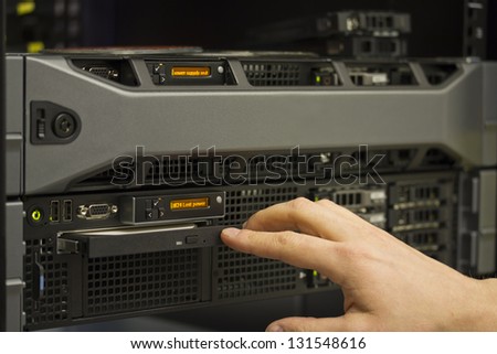 A technician install a 2 unit rack server in a data center.