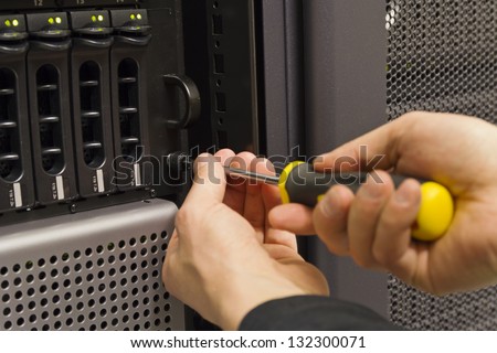 Installing server and disk cabinet / SAN in rack at a data center.