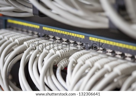 Close up of a gigabit ethernet switch with cat 5 / 5e / 6 patch cables connected.