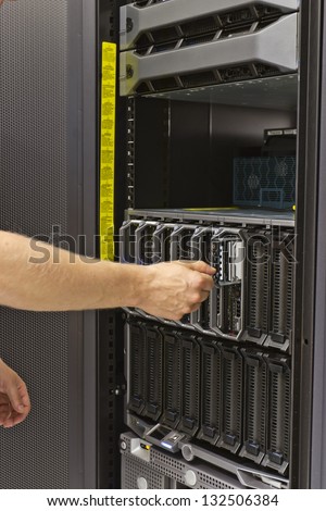 IT technician / consultant insert / remove a hard disk from a blade server in a data center. This is a 2,5\
