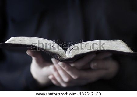 A close-up of a christian woman reading the bible. Very shallow depth of fields.