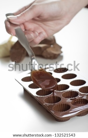 Woman making raw organic chocolate confectionery.
