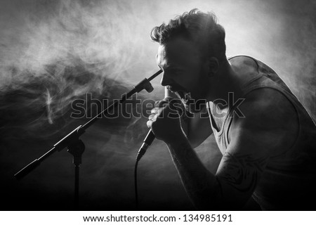 Young man sing / growls in hard rock concert.