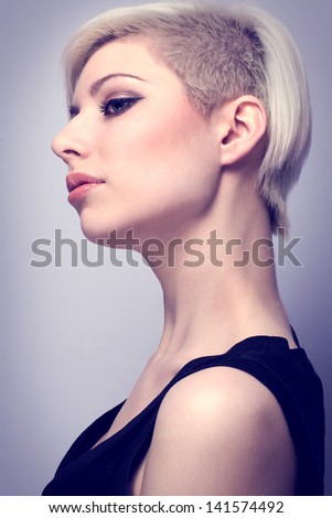 A beautiful and glamorous young woman with creative hair style. Colored and natural retouched.