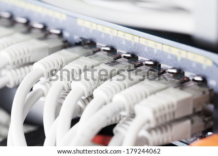 Close up of a gigabit ethernet switch with cat 5, 5e, 6 patch cables connected.