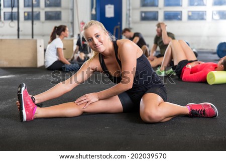 Blonde women stretching on the floor