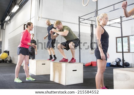 Workout group trains box jumps