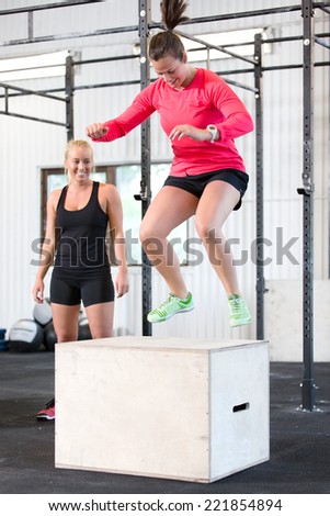 Woman trains box jumps with her team