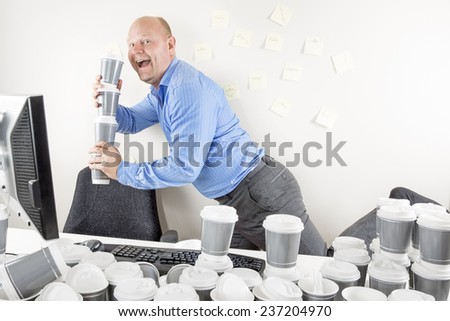 Happy businessman drinks too much coffee